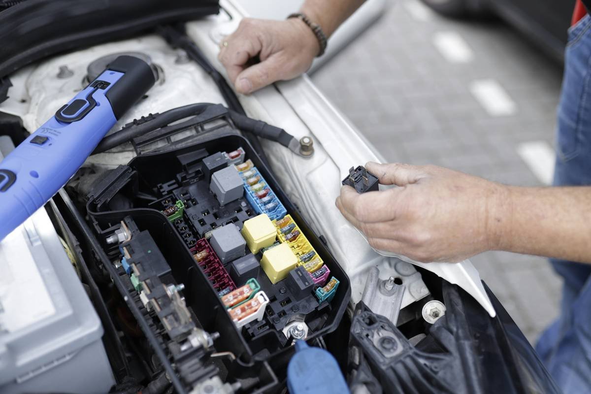 A mobile mechanic repairing a car on-site