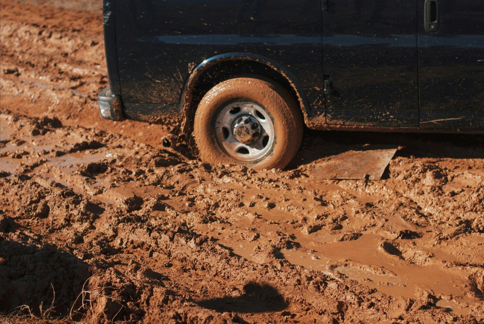 A stranded car stuck in mud after venturing off-road